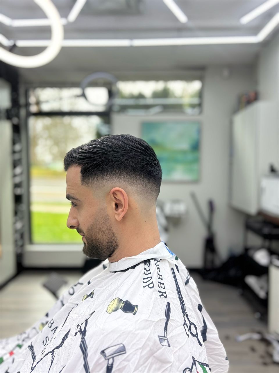 Mid skin fade with a sharp beard lineup at Royal Look Barber Shop in Broadmead Village, Saanich