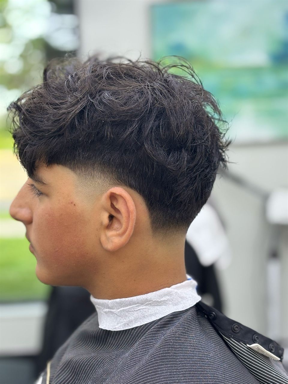 Low skin fade haircut at Royal Look Barber Shop in Broadmead Village, Saanich