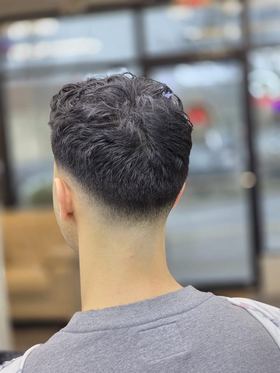 Mid skin fade finished at a barbershop near Royal Oak, Saanich