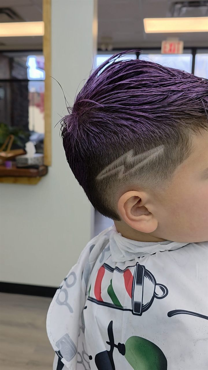 Skin fade with a custom hair design and colour at a Broadmead barbershop in Saanich